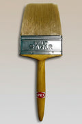 Paint brush with a wooden handle and metal ferrule on a textured surface