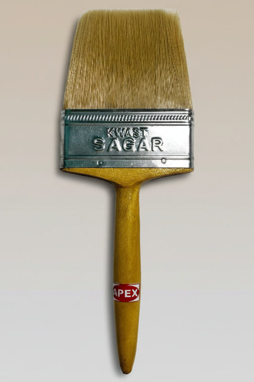 Paint brush with a wooden handle and metal ferrule on a textured surface